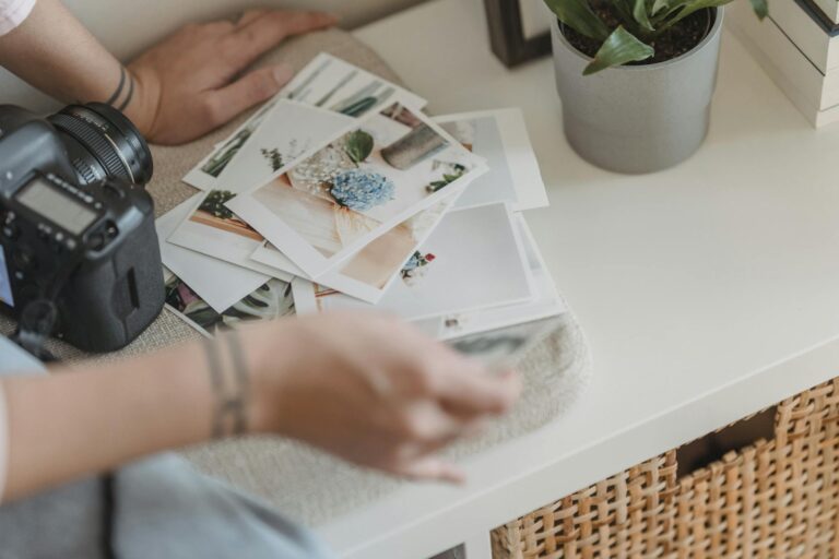 A relaxed home photography space with prints and camera on a desk, perfect for creative inspiration.