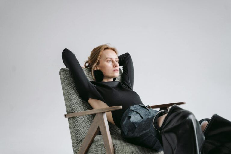 Woman in a modern chair, creating a scene of relaxation and contemplation indoors.